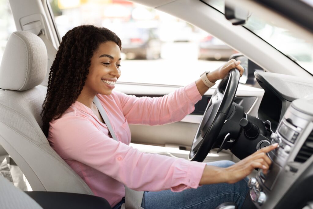 Side View Profile Portrait Of Happy Woman Driving Car And Listening To Music