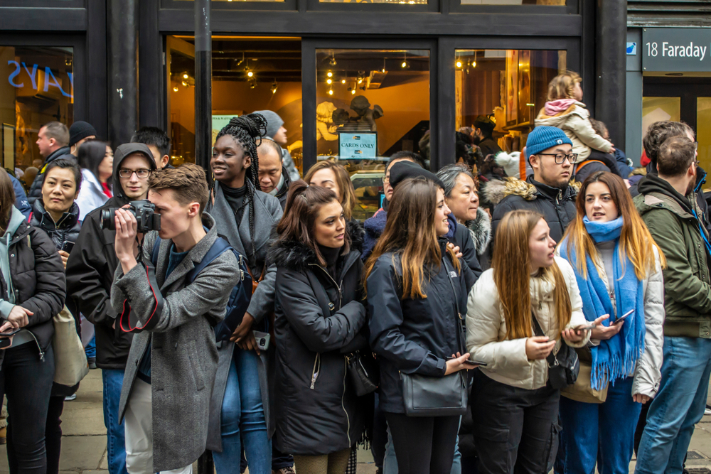 People standing in line outside of a store