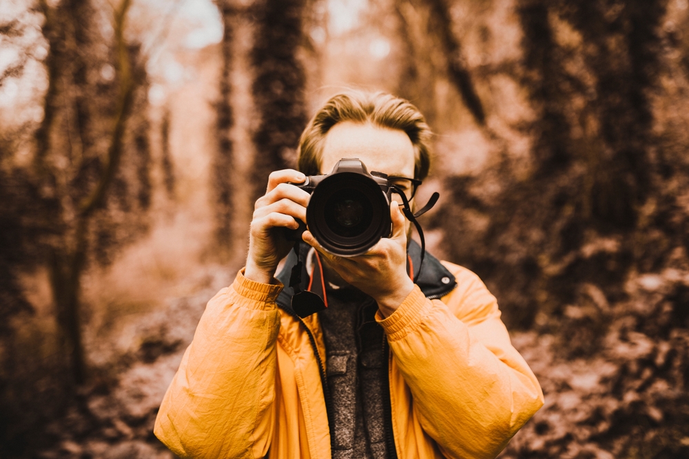 photographer in the woods, warm tone