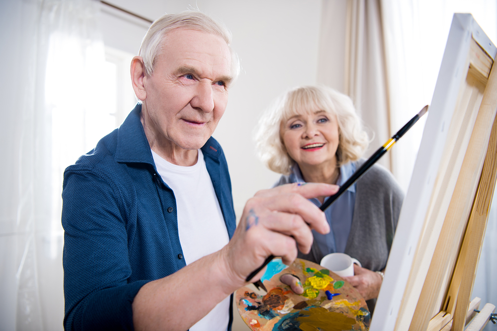 woman looking at husband painting