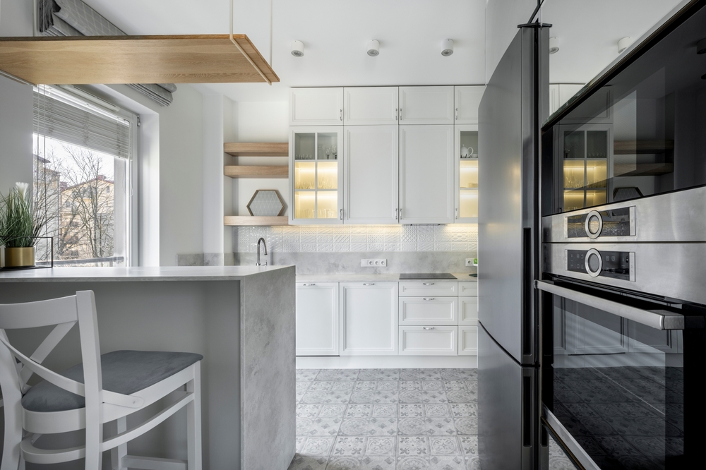 Modern interior design - open kitchen in the apartment in white finishing