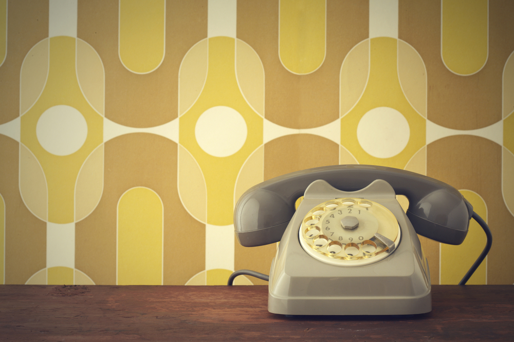 Old-fashioned phone on vintage background