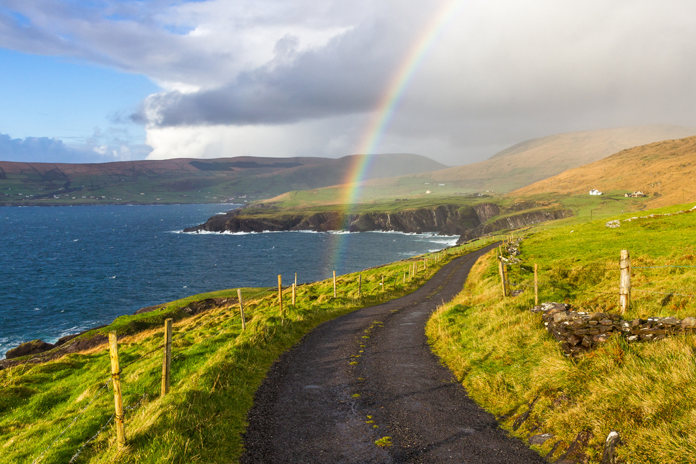 Typical Ireland - Coast, green grass, blue skies, clouds, rain coming, rainbow. Beautiful, amazing, breathtaking.