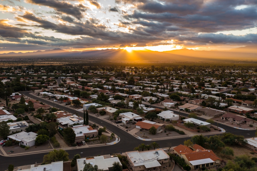 Scenic view of Green Valley Arizona during sunrise with sun rays and clouds.