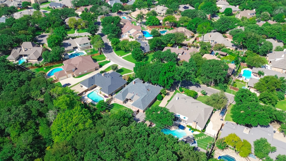 Greenbelt near residential neighborhood green community in North Arlington, Texas, sustainable urban planning reduce emissions Dallas suburbs houses with swimming pool, natural open space, aerial.