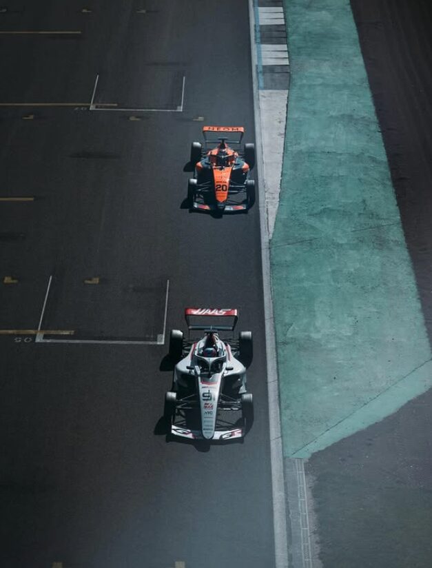 F1 Academy race cars overhead on track including Haas car number 91