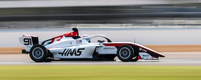 Kaylee Countryman F1 Academy driver in Haas car number 91 at speed on track