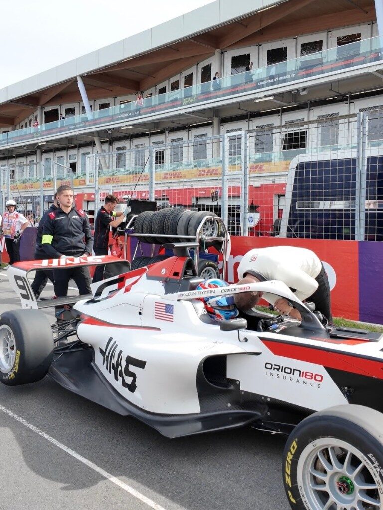 Kaylee Countryman in Haas car number 91 with pit crew on track